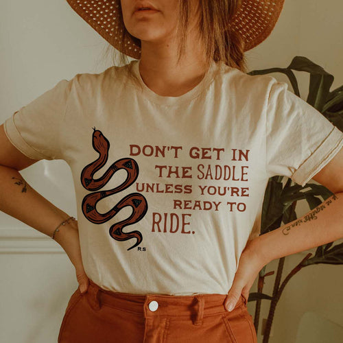 Shipping Dept. Don't Get In The Saddle Unless You're Ready To Ride - CREAM - THE ROAMING SAGUARO COLLECTION by Meghan Wolff